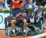 TOPSHOTSSerbia's Novak Djokovic sits on